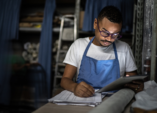 Man in workshop looking at a tablet