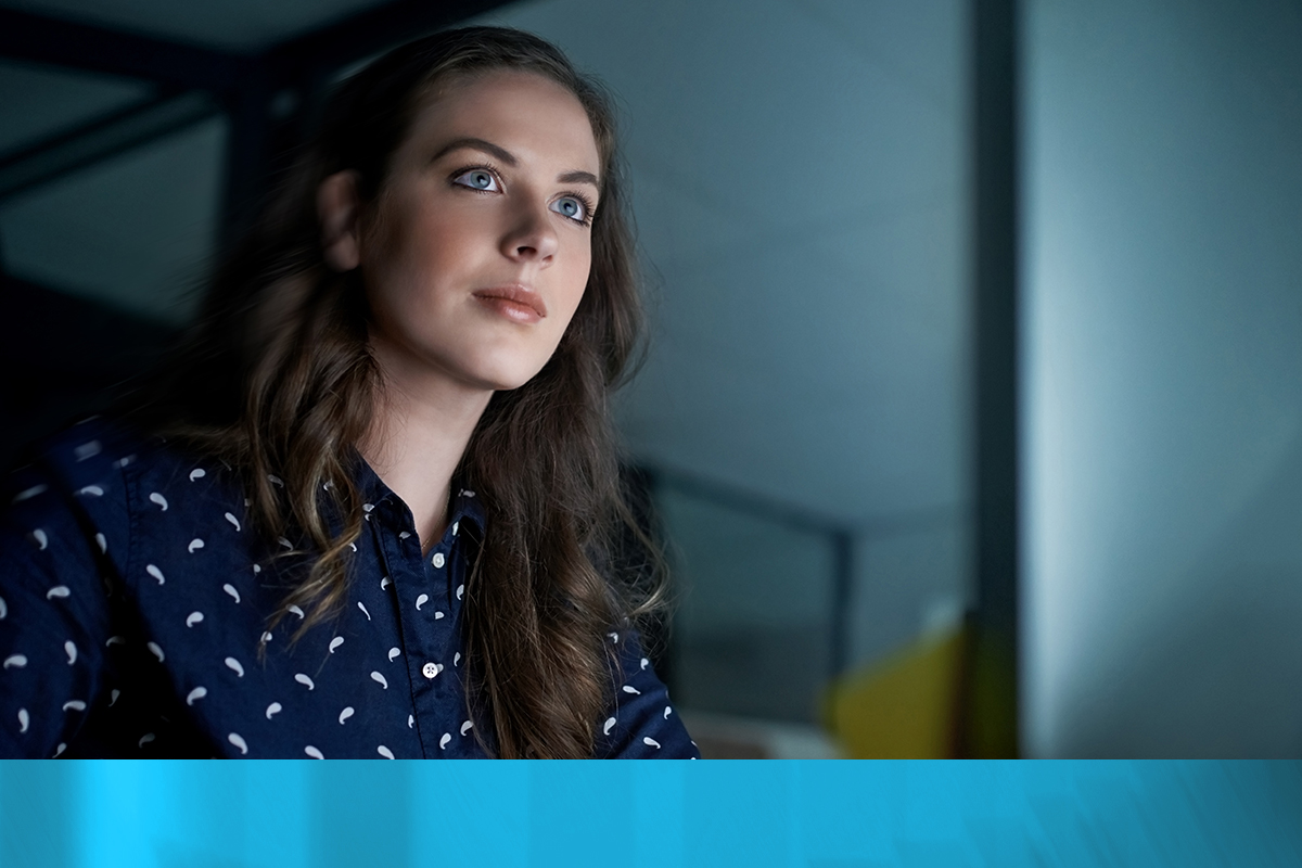 Young businesswoman working on computer while sitting at her desk