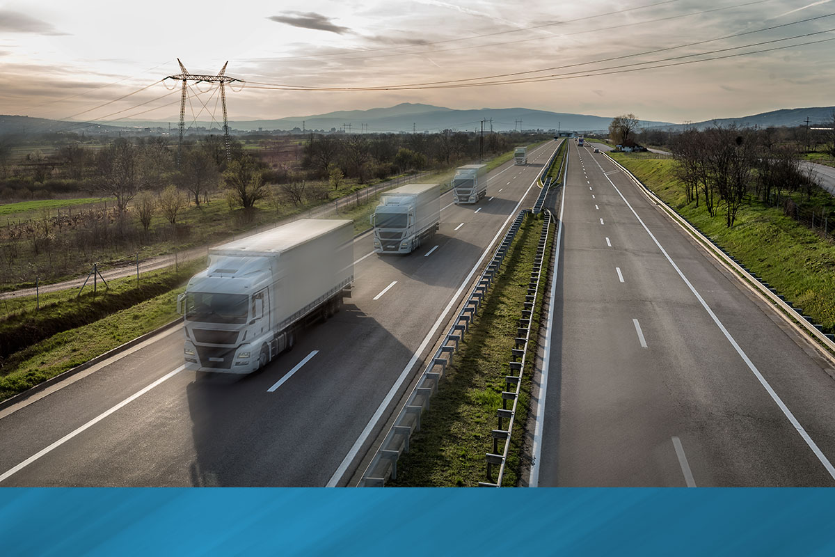 Convoy of delivery trucks on the highway.